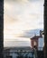 Vertical frame in a frame shot of a balcony  with concrete balusters and a cloudy horizon