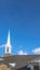 Vertical frame Gray roof and white steeple of church on winter view of snowy Wasatch Mountains