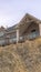 Vertical frame Home with dormer and two gable roofs over balcony with cloudy sky background