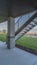 Vertical frame Home porch under a wooden brown ceiling supported by rectangular pillars