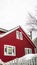 Vertical frame Home with red walls and front porch on a snowy mountain in Park City Utah