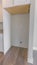 Vertical frame Interior of a kitchen with hanging cabinet above the empty refrigerator alcove