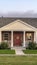 Vertical frame Modern face brick townhouse front facade near sunset