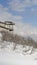 Vertical frame Mountainside home overlooking the valley and Wasatch Mountains under cloudy sky