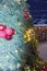 Vertical frame of a part of a Christmas tree, richly decorated for Christmas, standing in the backyard of a house