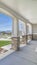 Vertical frame Porch with pillars and a combination of concrete and stone brick exterior walls