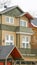 Vertical frame Selective focus of townhome with balcony and snowy roof against cloudy sky