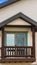 Vertical frame Small balcony with brown wooden railings and posts under a pitched roof