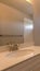 Vertical frame Vanity area toilet bathtub and shower inside the bathroom of a home