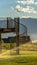 Vertical frame Yard water sprinkler and stairs of the balcony viewed against lake and mountain