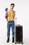 Vertical full-length shot thoughtful young asian guy standing near black suitcase, pack luggage decide travel abroad
