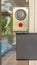 Vertical Glass door of a modern building with security key card reader and handicap sign