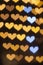 Vertical golden bokeh hearts background.