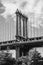 Vertical grayscale shot of the Brooklyn Bridge in New York City