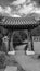 Vertical grayscale shot of an entrance to a Japanese temple