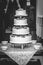 Vertical grayscale shot of a four leveled wedding cake