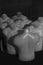 Vertical grayscale shot of male naked torso mannequins in sunlight