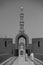 Vertical grayscale shot of the minaret of the Sultan Qaboos Grand Mosque in Muscat, Oman