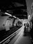 Vertical grayscale of a subway in a station in London