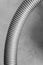 Vertical greyscale shot of the spiral tube of a vacuum cleaner