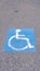 Vertical Handicapped icon painted on tarmac on a cloudy day