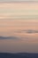 Vertical hazy sunset. Horizon under warm and faded pastel colours