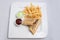 Vertical Hero shot of a beef wrap sandwich with samurai & alger sauce and fries on the side, on a minimal white background