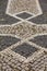 Vertical high angle closeup shot of a patterned cobblestone ground with tiles of different colors