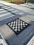 Vertical high angle shot of a chess board on the table in the yard