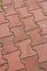 Vertical high angle shot of a patterned red cobblestone ground