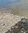 Vertical high angle shot of pebble stones on the seashore