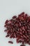 Vertical high angle shot of a pile of kidney beans on a white surface