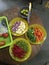 Vertical high angle shot of plates of fresh vegetables on a wooden table