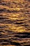 Vertical high-angle view of water waves at sunset