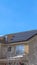 Vertical Home along Wasatch Mountain terrain with solar panels on the pitched roof