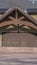 Vertical Home in Park City Utah in winter with gabled garage entrance against blue sky