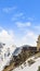 Vertical Houses built on top of a mountain blanketed with snow in winter