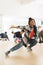 Vertical image of african american female hip hop dancer practicing at dance studio with copy space