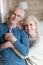 Vertical image aged positive spouses posing for camera