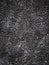 Vertical image close-up abstract background of gray and black color from decorative concrete. Lunar landscape