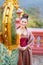 Vertical image and close up beautiful Asian woman with Thai traditional dress stand in front of the naga sculpture in temple area