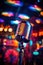 vertical image closeup stylish old retro microphone on multicolored karaoke bar bokeh background