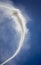 Vertical image of Column of smoke with tornado against blue sky from munitions explosion