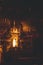 Vertical image of a dark church alter with an illuminated statue shrine