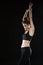 Vertical image of fitness woman holding hands overhead