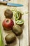 Vertical image at forty-five degrees of fruit pieces on a wooden board before being cut into small pieces with a well-sharpened