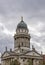 Vertical image of the Franzosischer Dom in the Gendarmenmarkt square, Berlin, Germany, on a typical winter day with cloudy skies