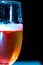 Vertical image of a glass of Champaign in the dark background with red and blue lights