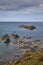 vertical image of an Irish beach with varied rocks