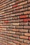 Vertical image of old brick wall with several colors of brick showcasing craftsmanship of work
